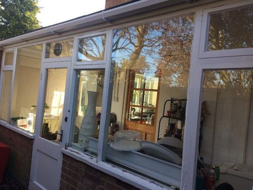 Wall rebuilt, new windows, new guttering — before